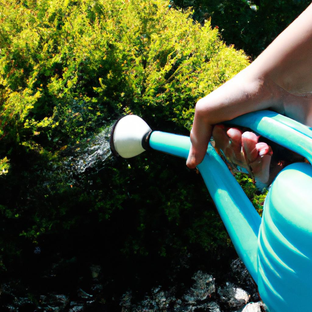 Person watering plants in garden